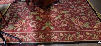 Good quality needlepoint type carpet with red ground and floral design with black border, 58cm