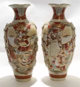 Two large Satsuma earthenware vases decorated in typical fashion with Japanese warriors and