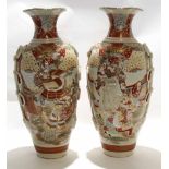 Two large Satsuma earthenware vases decorated in typical fashion with Japanese warriors and