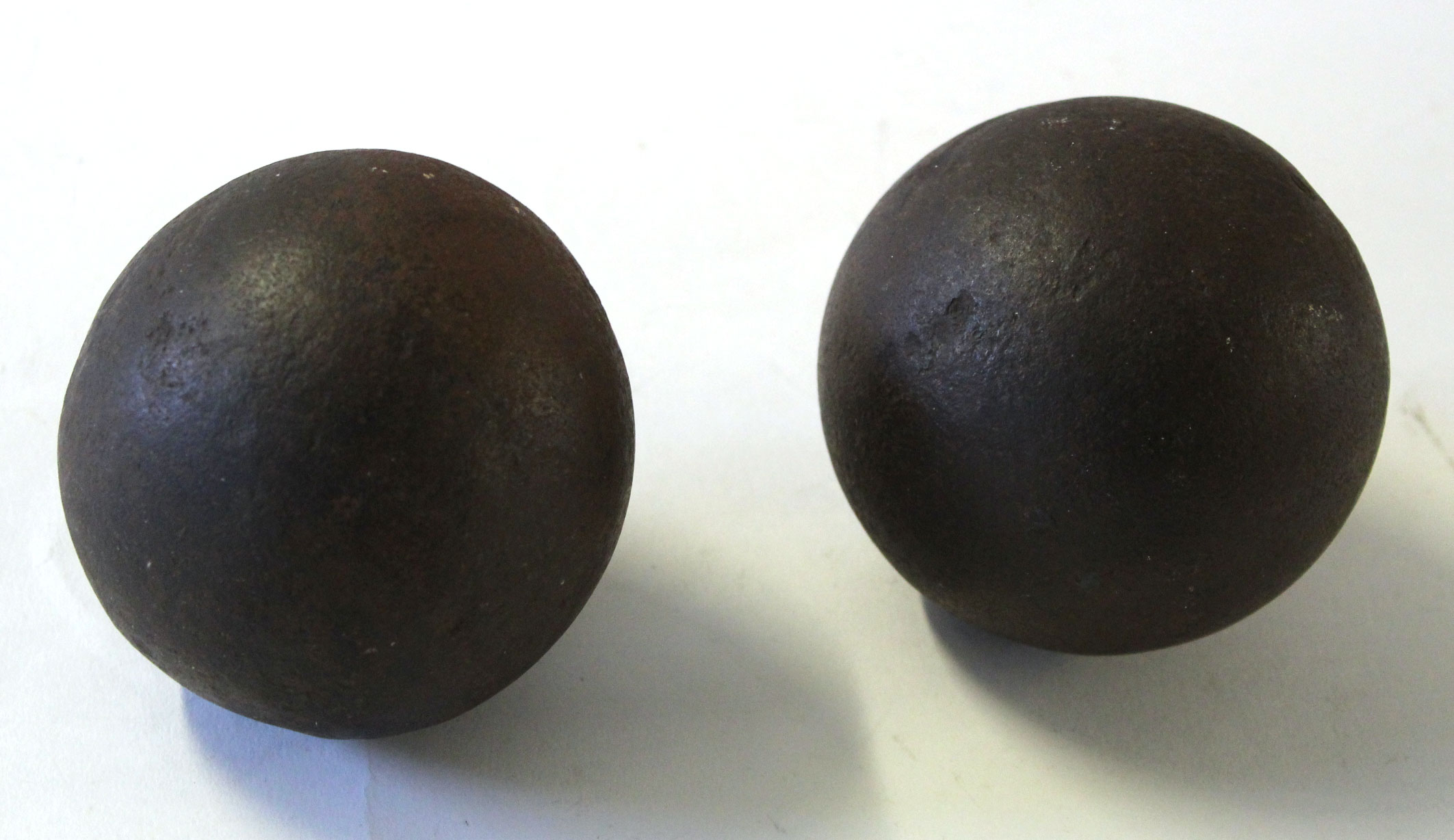 Two cannon shot, each approx 9cm diam