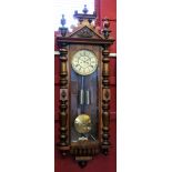 Victorian Vienna style wall clock with shaped pilasters, the gilt dial with Roman numerals and