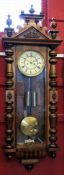 Victorian Vienna style wall clock with shaped pilasters, the gilt dial with Roman numerals and