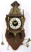 Dutch or Vienna style wall clock with silver dial and metal decoration above