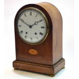 Early 20th century mahogany and boxwood lined inlaid mantel clock, the plain arched case on a plinth