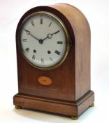 Early 20th century mahogany and boxwood lined inlaid mantel clock, the plain arched case on a plinth