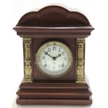 Early 20th century mantel clock with shaped brass pillars with white enamel dial white gilt