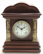 Early 20th century mantel clock with shaped brass pillars with white enamel dial white gilt