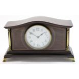 Edwardian mantel clock with brass pillars, white enamel dial and French movement, the clock raised