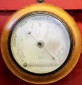 Circular barometer in a walnut frame, 27cm diam