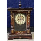 Wooden bracket clock with enamelled dial and Roman numerals, the case with turned woodwork to either