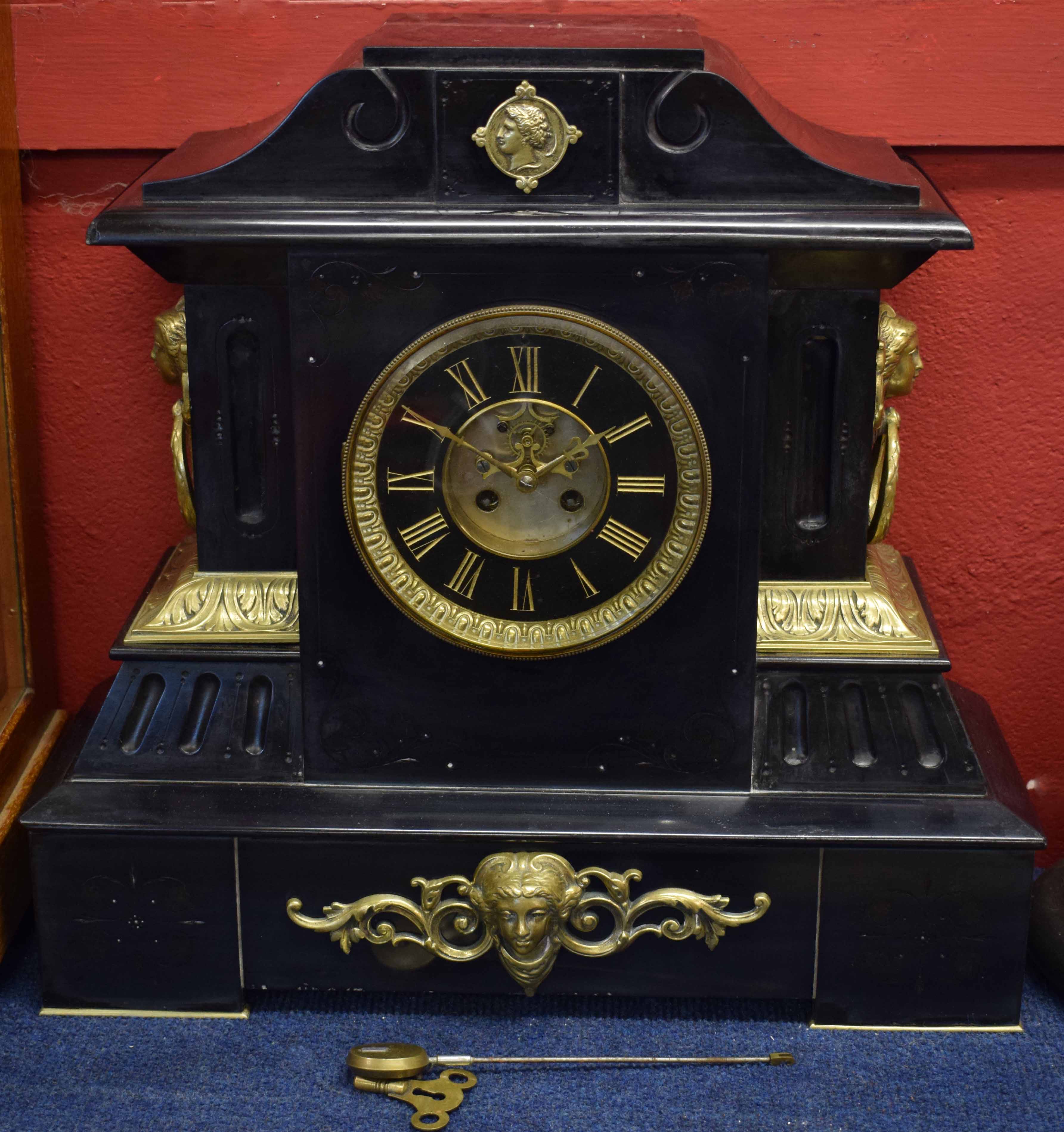 Late 19th century cast brass mounted black marble mantel clock, the plinth shaped case with