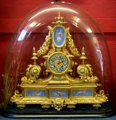 19th century gilt brass clock in Louis XV style, under a large glass dome, the gilt face with blue