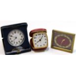 Travelling alarm clock, by Coral, in red leather case