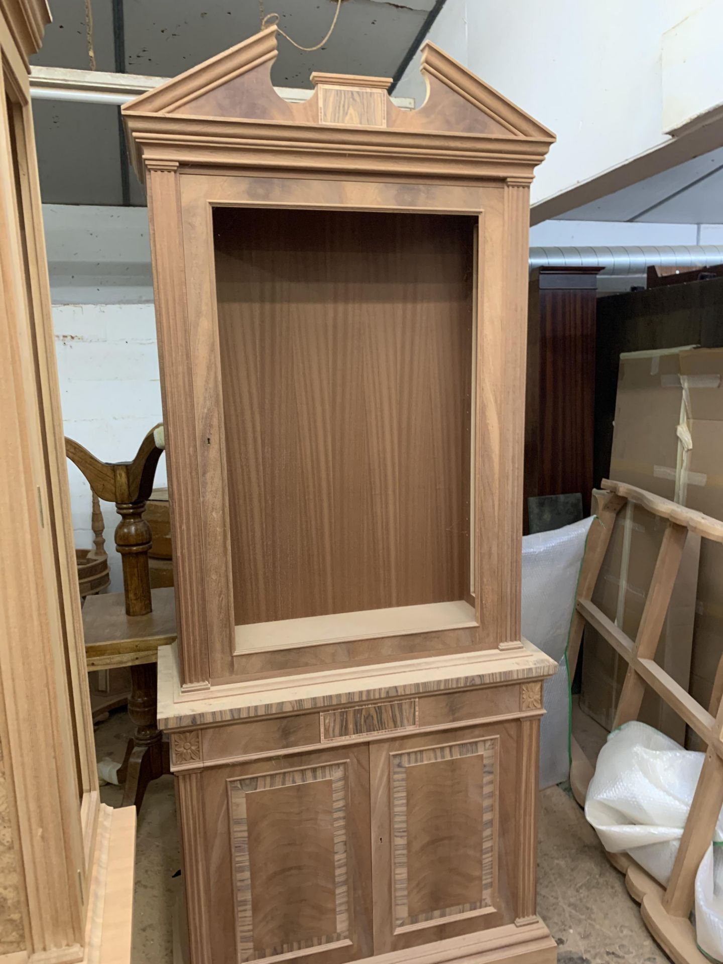 Two-door tall Bookcase, in mahogany finish, from the Corinthian range, requires finishing/polishing.