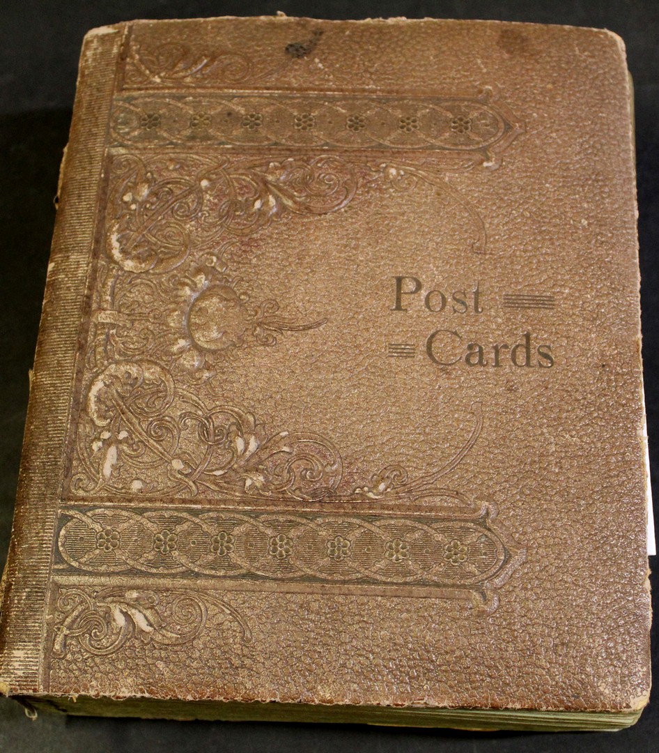 Postcard album containing approx 150 picture postcards, many with divided backs, including