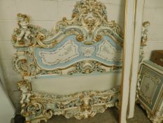VERY GOOD QUALITY PAINTED AND GILDED DOUBLE BED WITH HEAVILY CARVED DETAIL MOUNTED ON PUTTI