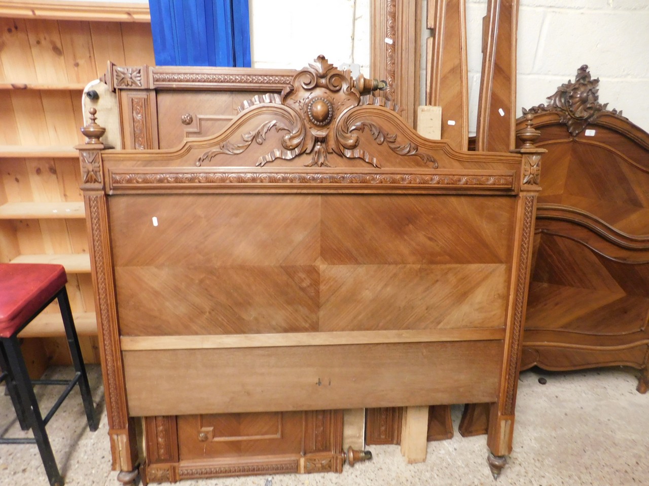 FRENCH WALNUT DOUBLE BED WITH HEAVILY CARVED PANELLED BACK AND FOOT BOARD WITH URN TURNED FINIALS