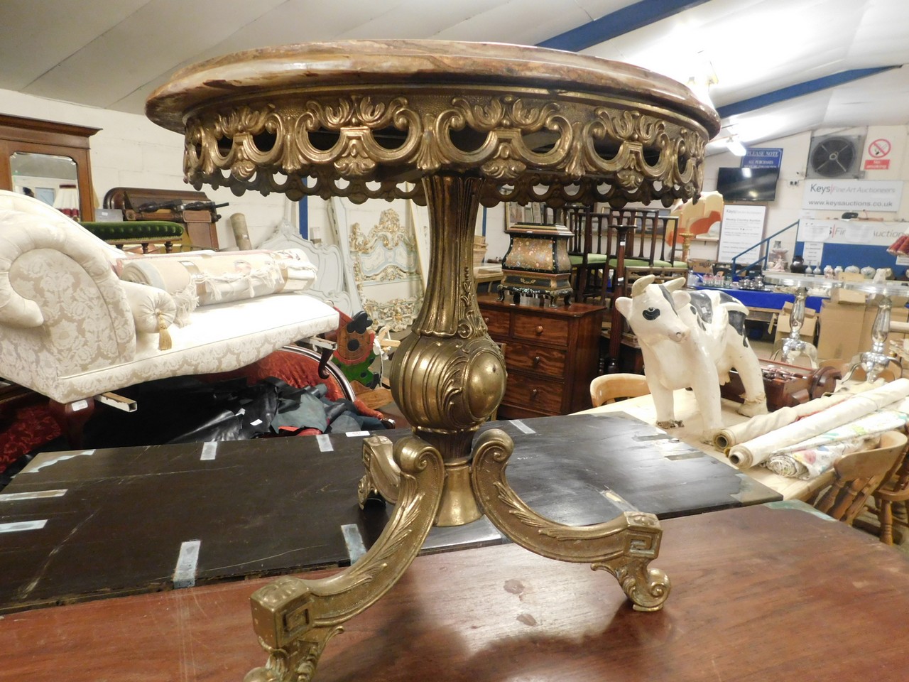 CAST BRASS AND ONYX TOP TABLE WITH AN OPEN WORK FRIEZE AND A TRIPOD BASE