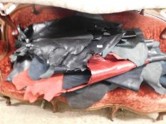 LARGE QUANTITY OF BLACK AND RED LEATHER HIDES OR PART HIDES