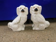 PAIR OF 19TH CENTURY STAFFORDSHIRE WHITE AND GILDED DOGS (A/F)