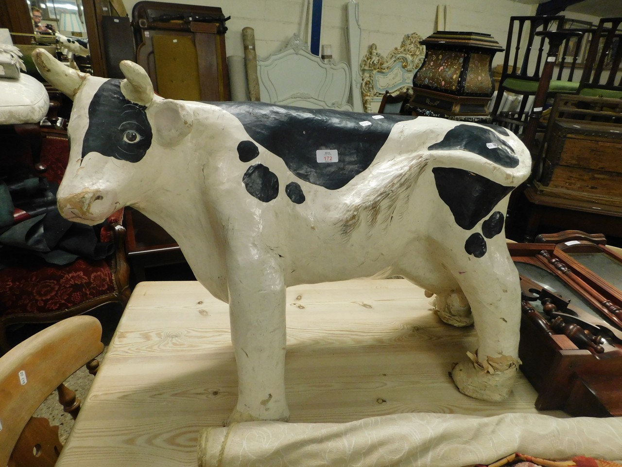 PAPER MACHE AND PAINTED MODEL OF A COW
