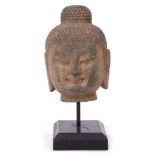 Chinese Tibetan or Thai stoneware model of a Buddha with tightly curled hair and elongated ear lobes