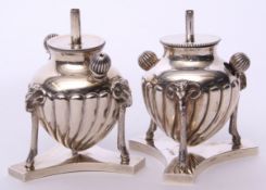 Near pair of late Victorian table lighters of fluted baluster form supported on three rams mask legs