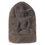 Indo-Javanese model of a Hindu deity, on a stoneware base with a domed stoneware background, 32cm