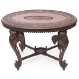 Anglo Indian hardwood oval occasional table raised on four elephant mask supports with bone