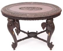 Anglo Indian hardwood oval occasional table raised on four elephant mask supports with bone