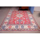 Oriental carpet with triple gull border, central geometric floral lozenge flanked by two others,
