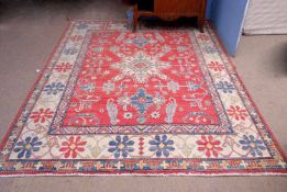 Oriental carpet with triple gull border, central geometric floral lozenge flanked by two others,