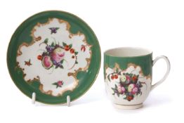 18th century Worcester cup and saucer, the apple green ground decorated to the centre with fruit