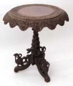 Anglo-Indian hardwood pedestal table, circular top with a swept shaped frieze raised on central