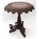 Anglo-Indian hardwood pedestal table, circular top with a swept shaped frieze raised on central