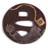 Japanese iron Tsuba signed by Yuzen, circa 1830-1840, decorated in gold and white metal on bronze