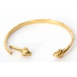 Antique torc bangle featuring two rams head finials (broken), unmarked, tests for 18ct gold, 23.