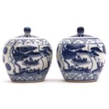 Two Chinese jars with covers, decorated with a blue and white design, six character mark to base,