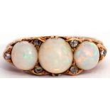 Antique opal and diamond ring featuring three graduated circle cabochon opals interspersed by six