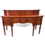 Regency period mahogany serving table of break front form, the pediment inset with sliding door