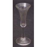 Mid-18th century wine glass, the bell shaped bowl above a clear stem, 19cm high
