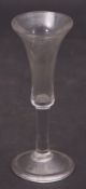 Mid-18th century wine glass, the bell shaped bowl above a clear stem, 19cm high