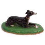 19th century Copeland & Garrett model of a greyhound, the black hound seated on an oval green