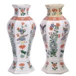 Pair of famille vert vases of faceted form decorated in enamels with vases on tables interspersed