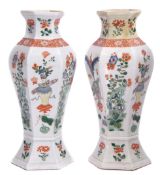 Pair of famille vert vases of faceted form decorated in enamels with vases on tables interspersed