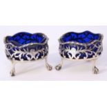 Pair of George III pierced circular salts with wavy gadrooned rims and supported on three claw and