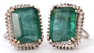 Pair of modern emerald and diamond cluster stud earrings, the octagon shaped earrings surrounded