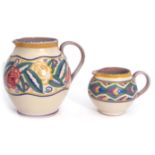 Two 1930s Poole Pottery globular jugs, the larger with a design of roses and flowers, the smaller