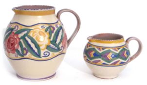 Two 1930s Poole Pottery globular jugs, the larger with a design of roses and flowers, the smaller