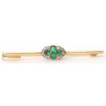 Emerald and diamond cluster bar brooch, the oval shaped centre with four small oval emeralds